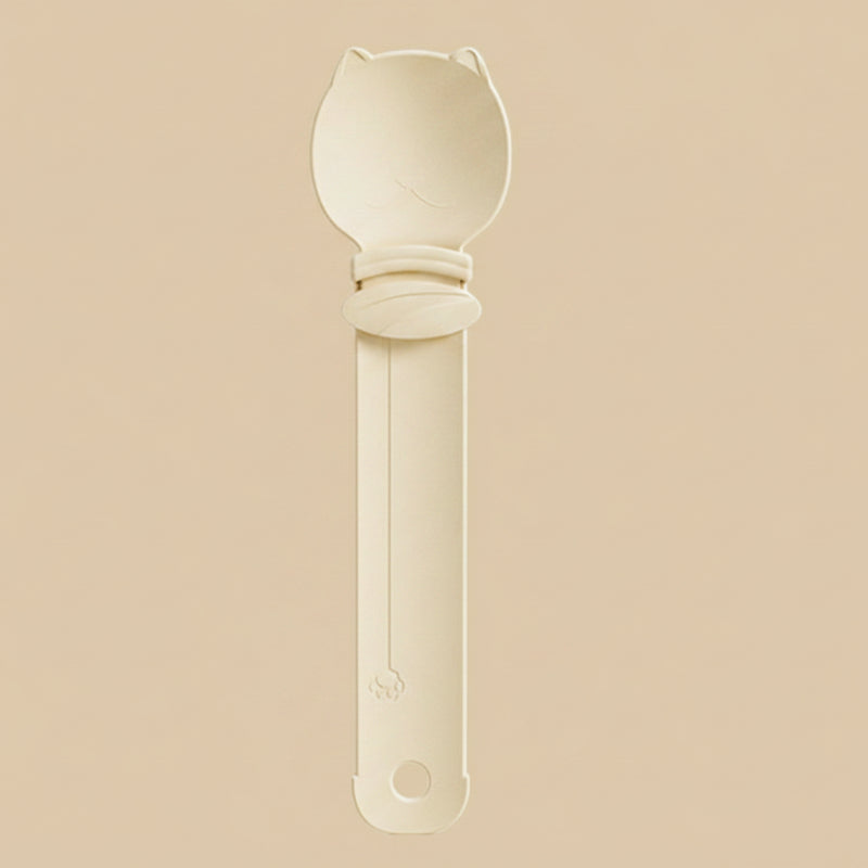 Beige spoon with a long handle on a white background