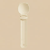 Beige spoon with a long handle on a white background