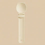 Beige spoon with a long handle on a white background