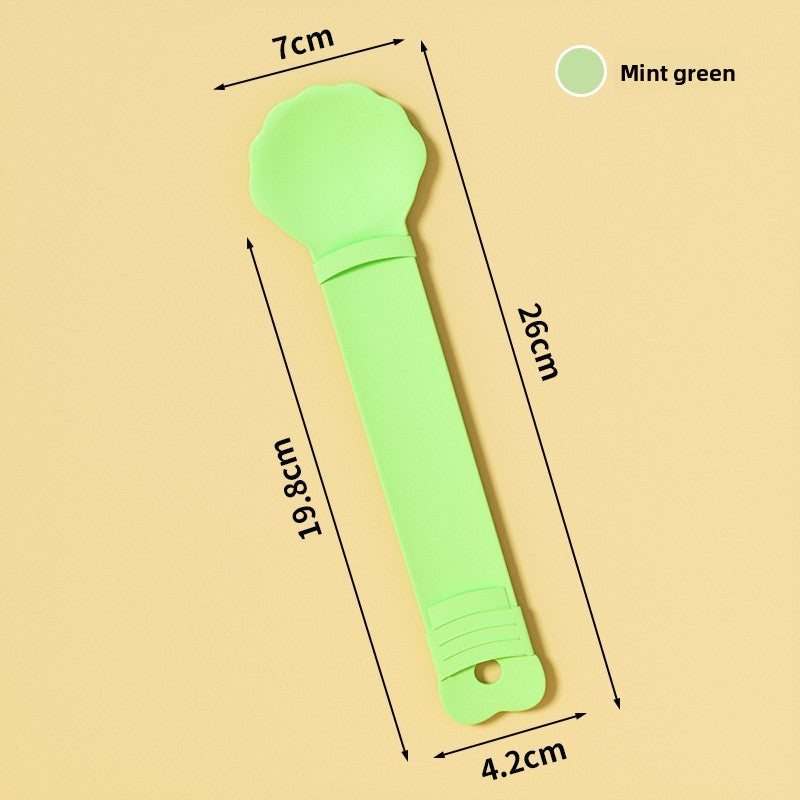 Mint green baby rattle with measurements on a beige background