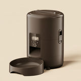 Black pet feeder with digital display on a white background