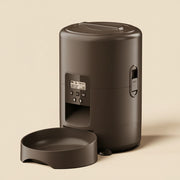 Black pet feeder with digital display on a white background