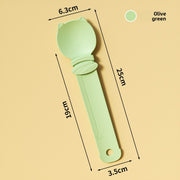 Olive green ice cream scoop with measurements on a beige background
